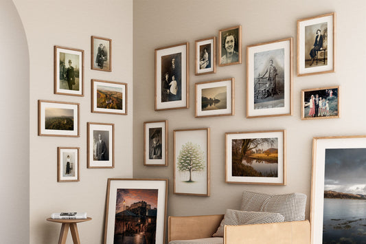 a corner of a room showing the walls covered with an arrangement of picture frames that form an ancestry wall